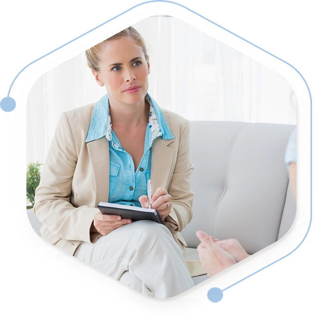 A woman sitting on top of a couch holding a tablet.