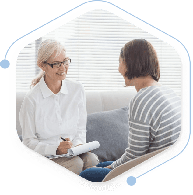 A woman sitting on the couch talking to someone